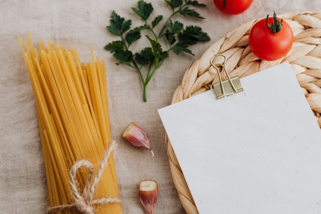 Uncooked spaghetti with tomatoes, garlic, and parsley on a rustic setup.